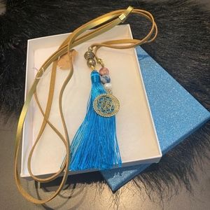 Gold leather necklace with blue tassel and crystal